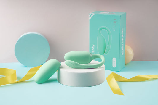 Mint green Kegel trainer and retail box in a pastel product display.