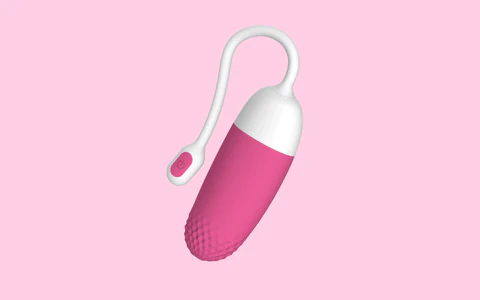 Pink Magic Vini bullet vibrator on a light pink background.