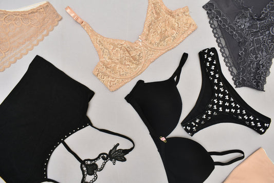 Flat lay of black and beige lace lingerie.