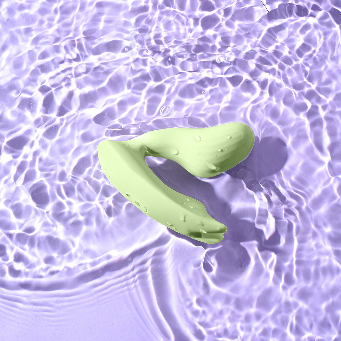Magic Umi Green wearable vibrator shown in water for IPX6 water resistance