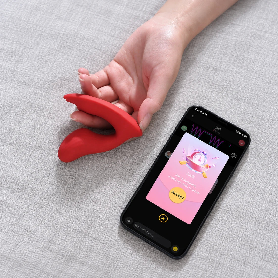 Red Magic Umi held beside a phone showing a partner invitation